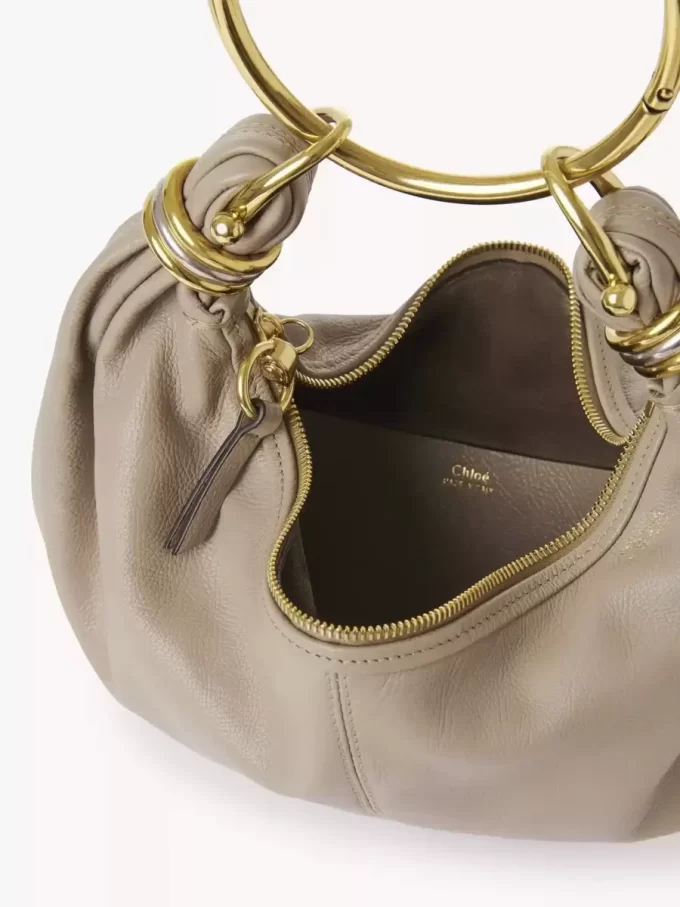 Kleine Hobo-Tasche mit Armband aus genarbtem Leder Kleine Hobo-Tasche mit Armband aus genarbtem Leder