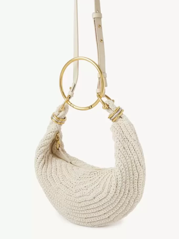 Kleine Hobo-Tasche mit Armband aus Häkelarbeit Kleine Hobo-Tasche mit Armband aus Häkelarbeit