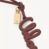 Taschenanhänger mit Logo aus glänzendem Leder Taschenanhänger mit Logo aus glänzendem Leder